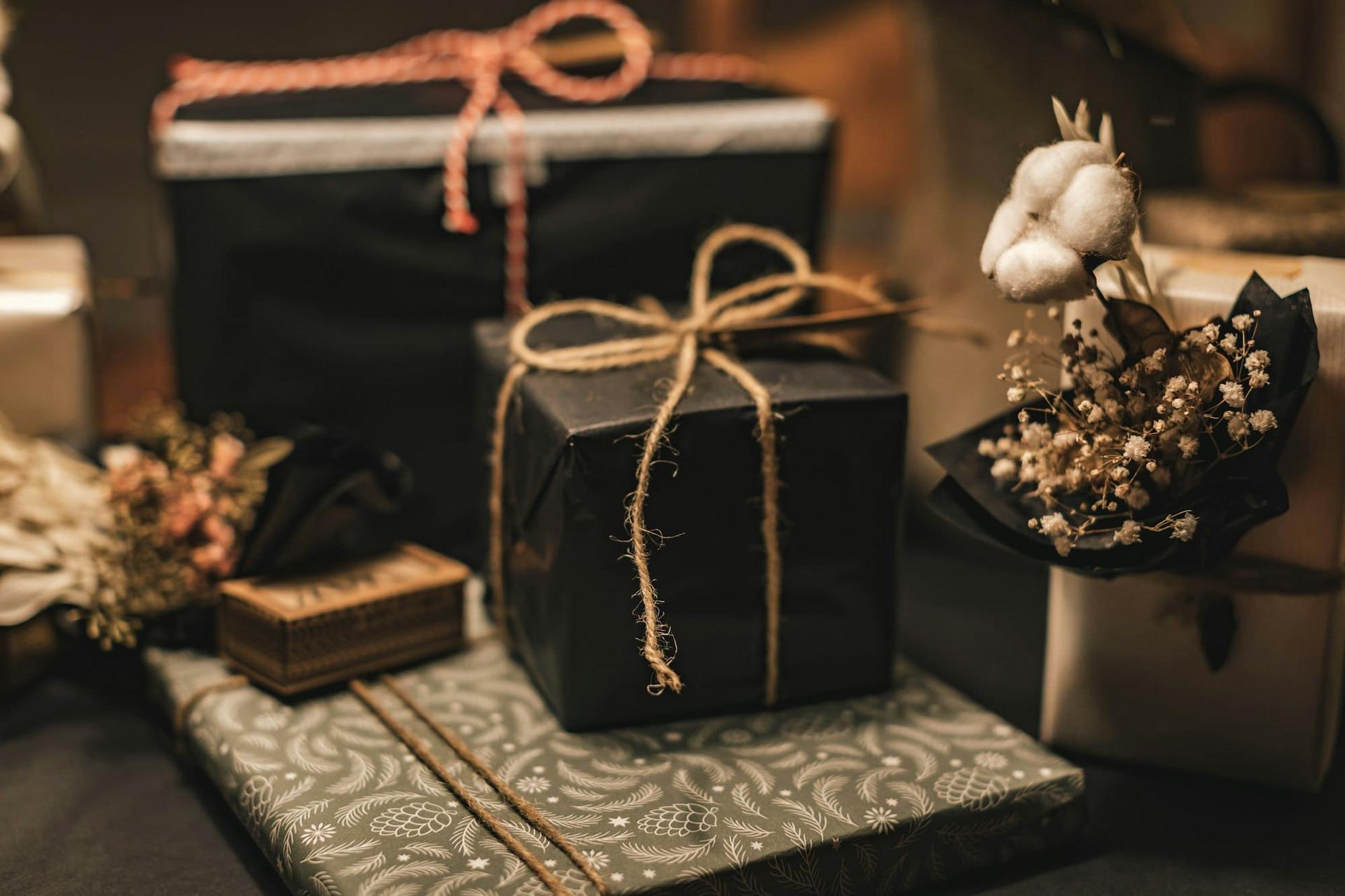 Gifts wrapped in black paper and tied with natural twine